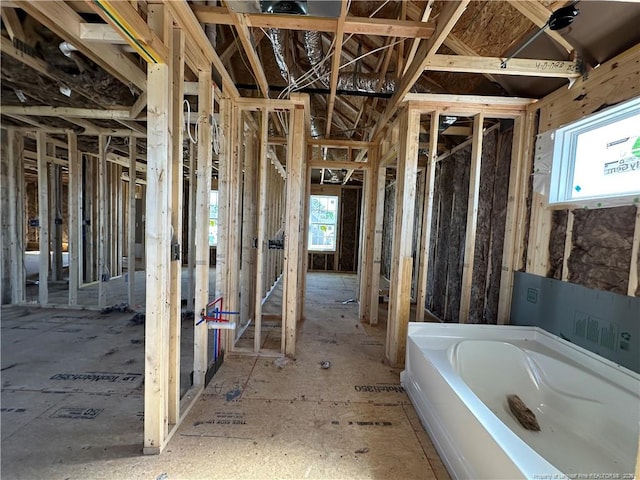 full bathroom with washer / clothes dryer and a garden tub