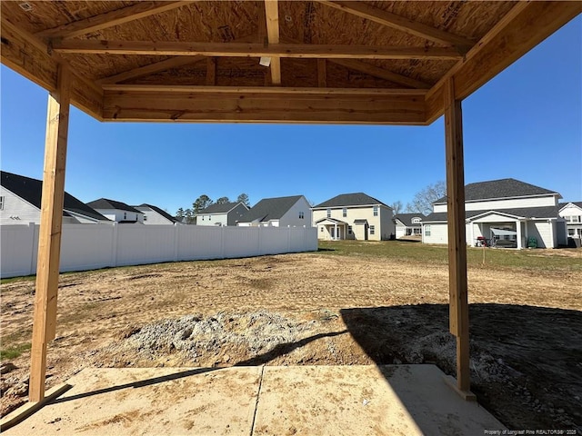 view of yard with a residential view and fence