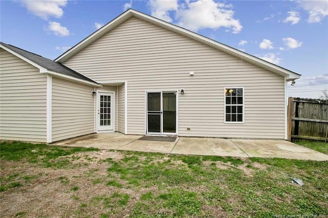 rear view of house with a yard and a patio