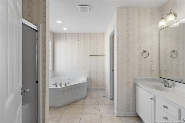 bathroom featuring a washtub, vanity, and tile patterned floors