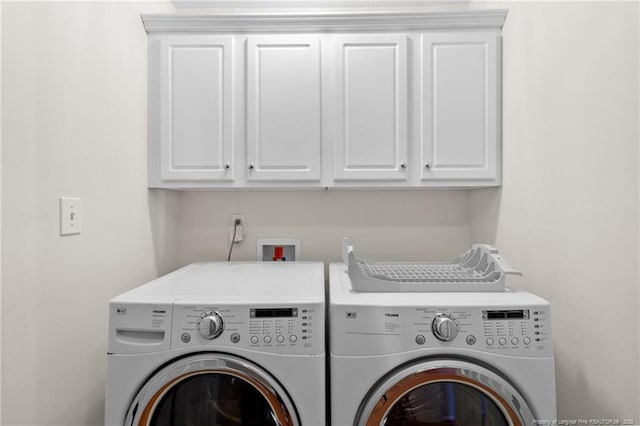 washroom with separate washer and dryer and cabinets