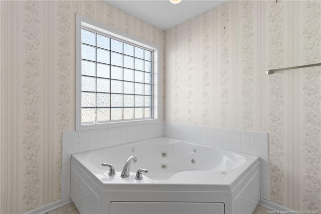 bathroom featuring a wealth of natural light and a bathing tub