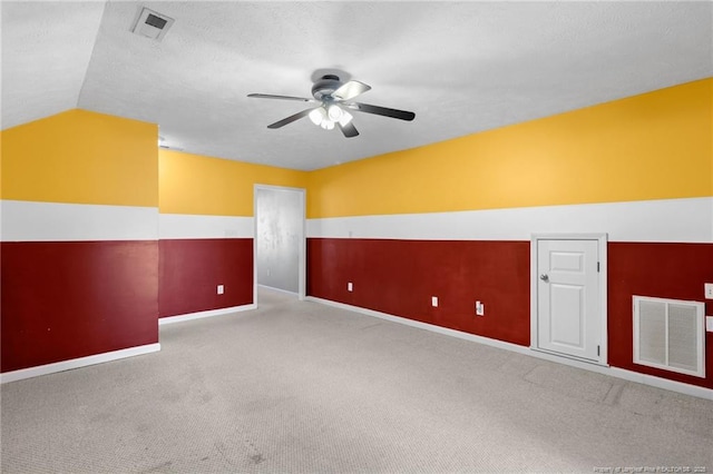 unfurnished room with light colored carpet, ceiling fan, and vaulted ceiling