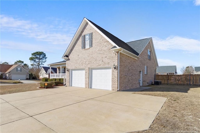 view of property exterior with cooling unit and a garage