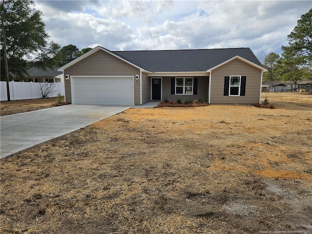 single story home featuring a garage, fence, and concrete driveway