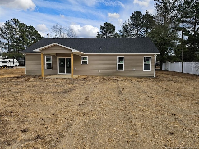 rear view of property with fence