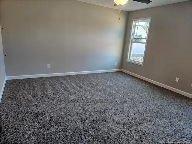 spare room featuring ceiling fan, carpet flooring, and baseboards