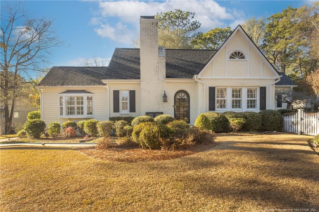 tudor house featuring a front lawn