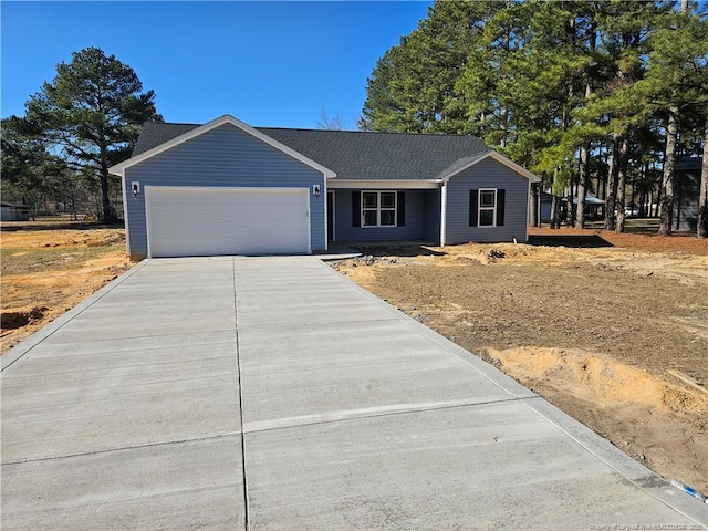 ranch-style home featuring a garage, roof with shingles, and driveway