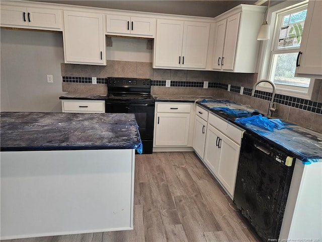 kitchen with black appliances, decorative backsplash, white cabinetry, and light wood-style floors