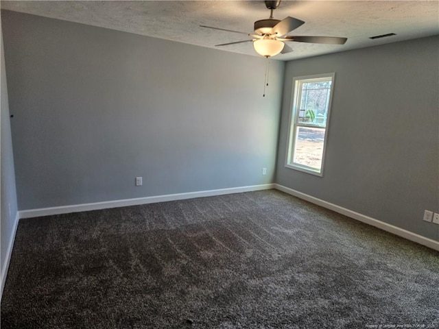 carpeted spare room featuring visible vents, ceiling fan, a textured ceiling, and baseboards