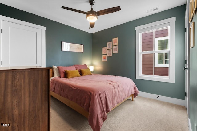 bedroom with light carpet and ceiling fan