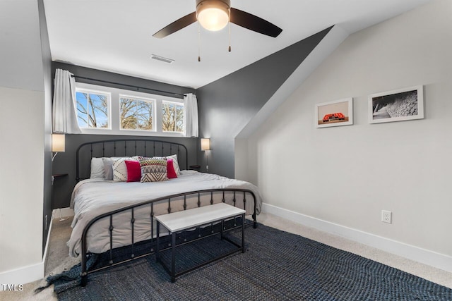 bedroom with vaulted ceiling, ceiling fan, and carpet flooring