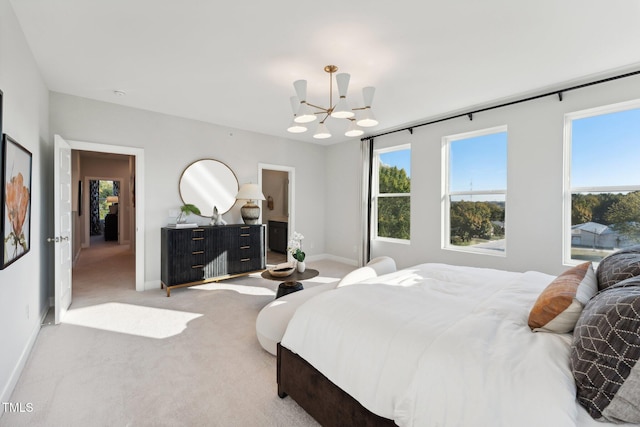 bedroom featuring a notable chandelier and light carpet