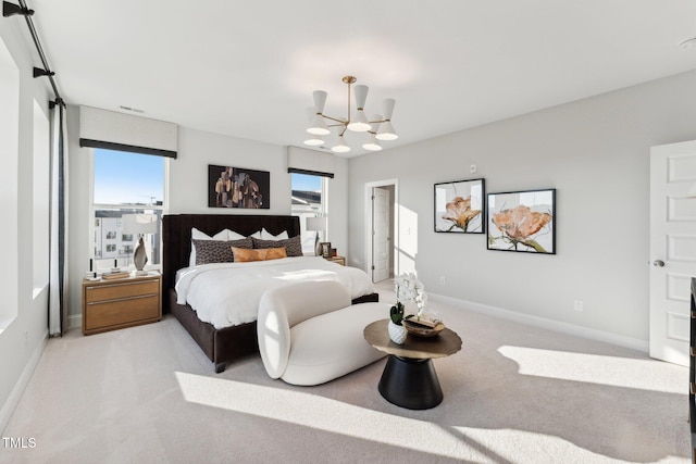 bedroom with light colored carpet and an inviting chandelier