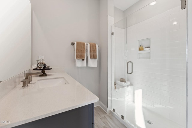 bathroom with walk in shower and vanity