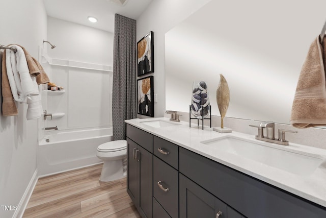 full bathroom featuring toilet, shower / bathing tub combination, hardwood / wood-style floors, and vanity