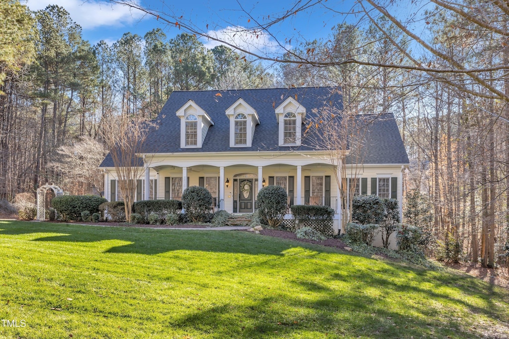 cape cod-style house with a porch and a front lawn