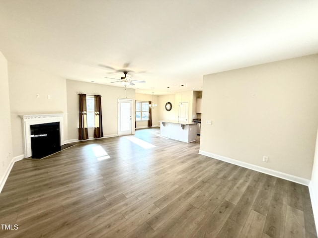 unfurnished living room featuring hardwood / wood-style flooring and ceiling fan