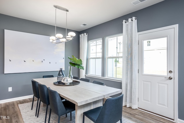 dining area with a chandelier and hardwood / wood-style floors