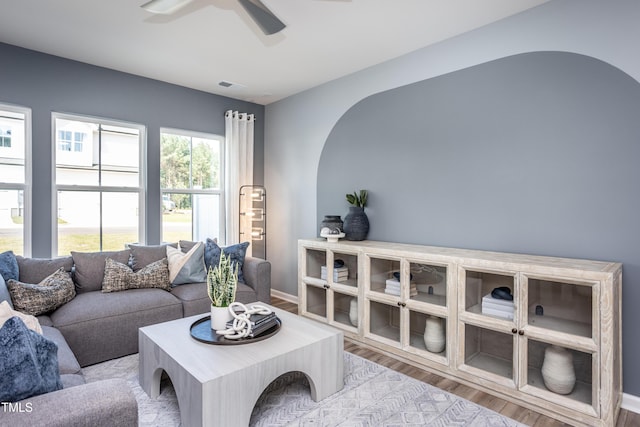 living room featuring ceiling fan and light hardwood / wood-style floors