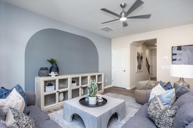 living room with ceiling fan and light hardwood / wood-style flooring