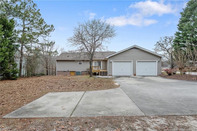 ranch-style house with a garage and a wooden deck