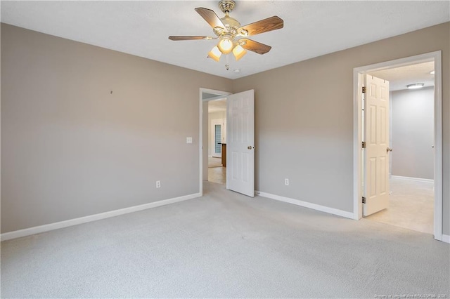 unfurnished bedroom with light colored carpet and ceiling fan