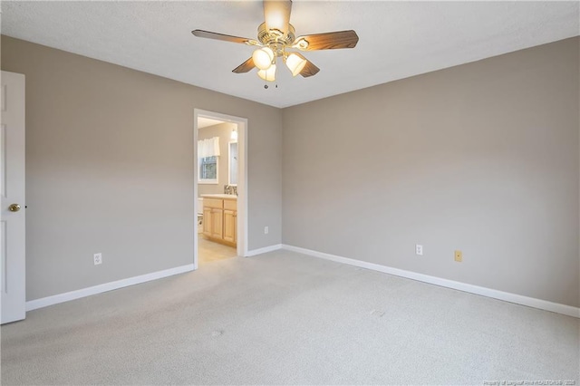 carpeted empty room with sink and ceiling fan