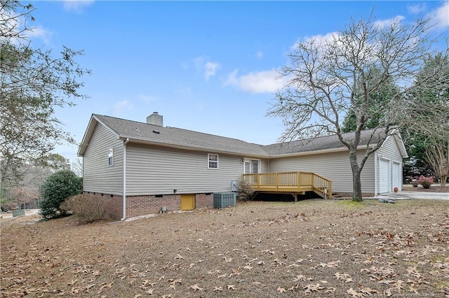 back of property featuring central AC unit, a garage, and a wooden deck