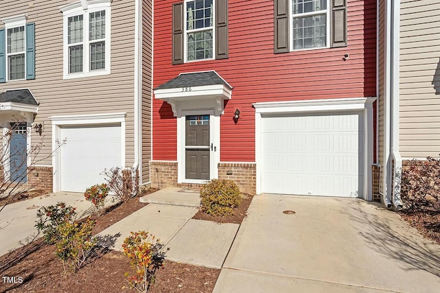 doorway to property with a garage