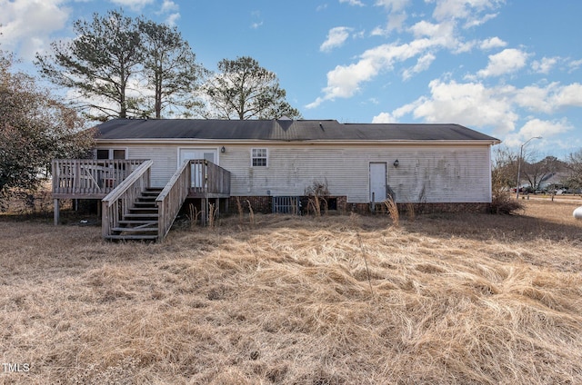 back of property featuring a deck