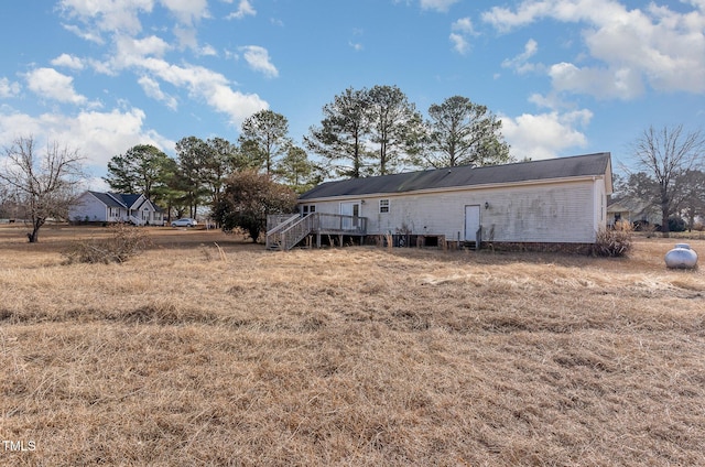 rear view of property featuring a deck