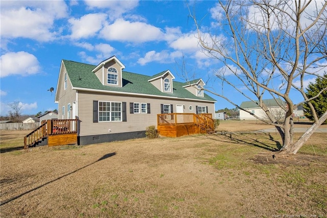 view of front facade featuring a deck and a front yard