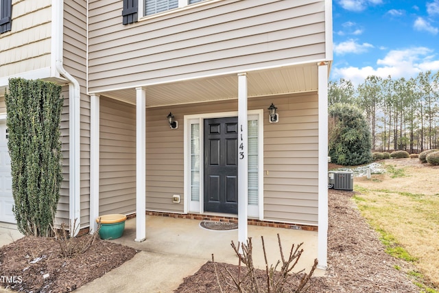 view of exterior entry featuring central AC unit