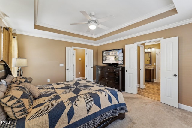 bedroom featuring ornamental molding, ceiling fan, a tray ceiling, and light carpet