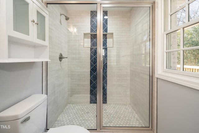 bathroom with walk in shower and toilet