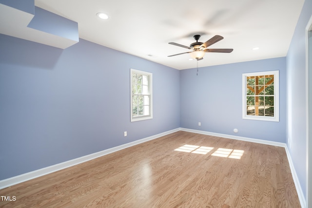 empty room featuring ceiling fan and light hardwood / wood-style floors