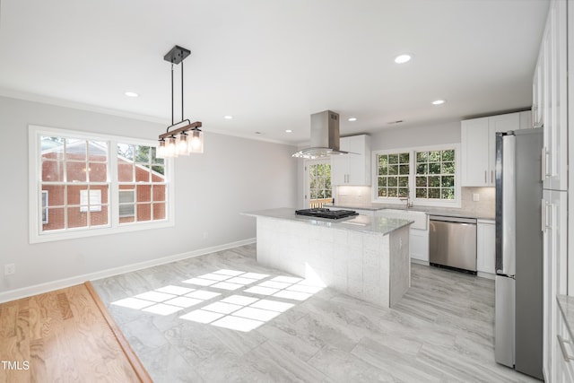 kitchen featuring pendant lighting, stainless steel appliances, light stone counters, white cabinets, and island exhaust hood