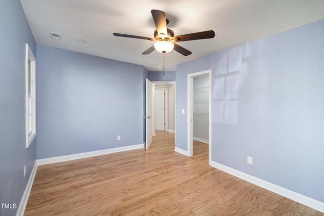 empty room with light hardwood / wood-style flooring and ceiling fan