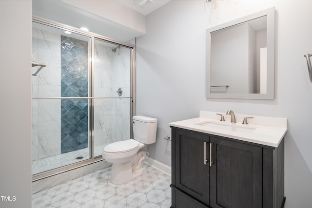 bathroom featuring vanity, an enclosed shower, and toilet