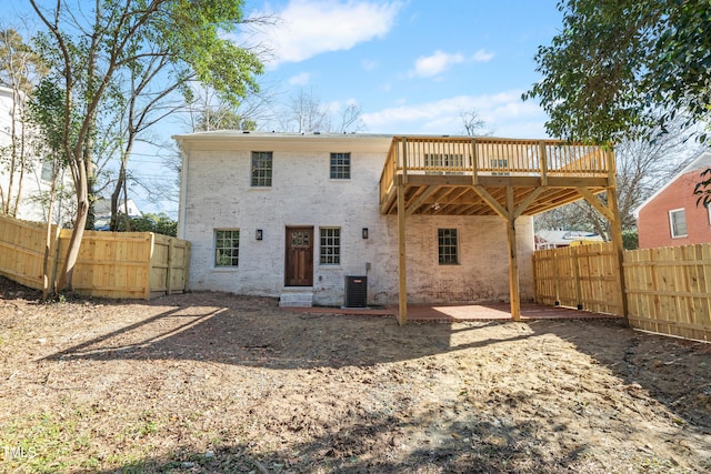 back of house with cooling unit, a deck, and a patio area