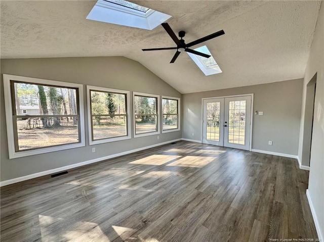 empty room featuring ceiling fan, dark hardwood / wood-style flooring, french doors, and a textured ceiling