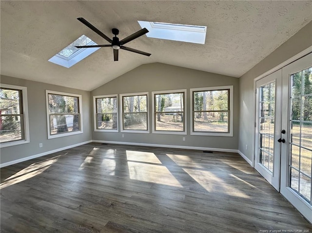 unfurnished sunroom with french doors, ceiling fan, and vaulted ceiling with skylight