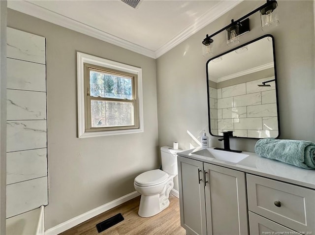 bathroom with toilet, wood-type flooring, walk in shower, vanity, and crown molding