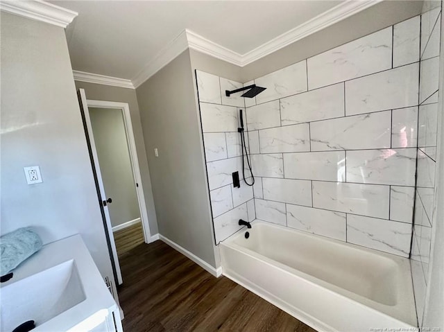 bathroom with tiled shower / bath combo, crown molding, wood-type flooring, and vanity