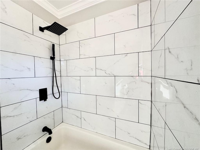 bathroom featuring ornamental molding and tiled shower / bath combo