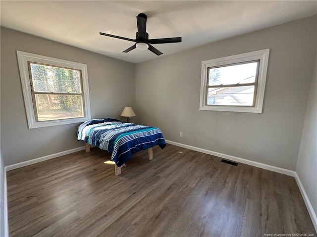 unfurnished bedroom with dark hardwood / wood-style flooring and ceiling fan