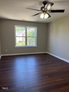 unfurnished room featuring dark wood-type flooring and ceiling fan