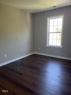 spare room with dark hardwood / wood-style flooring